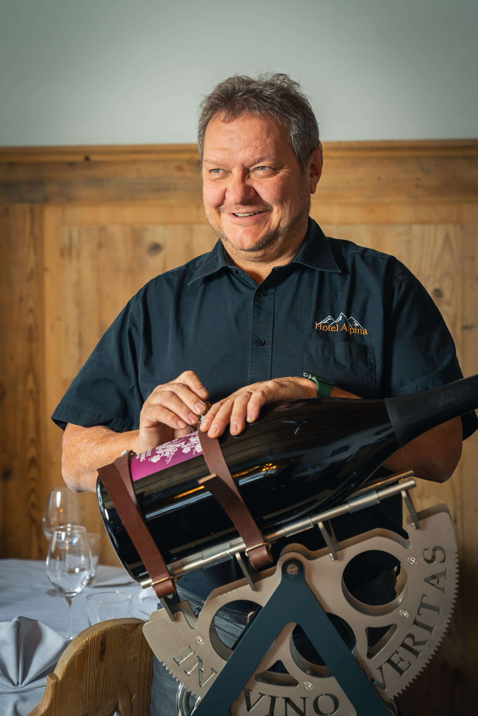 Reto, owner and host, presenting a large bottle of wine