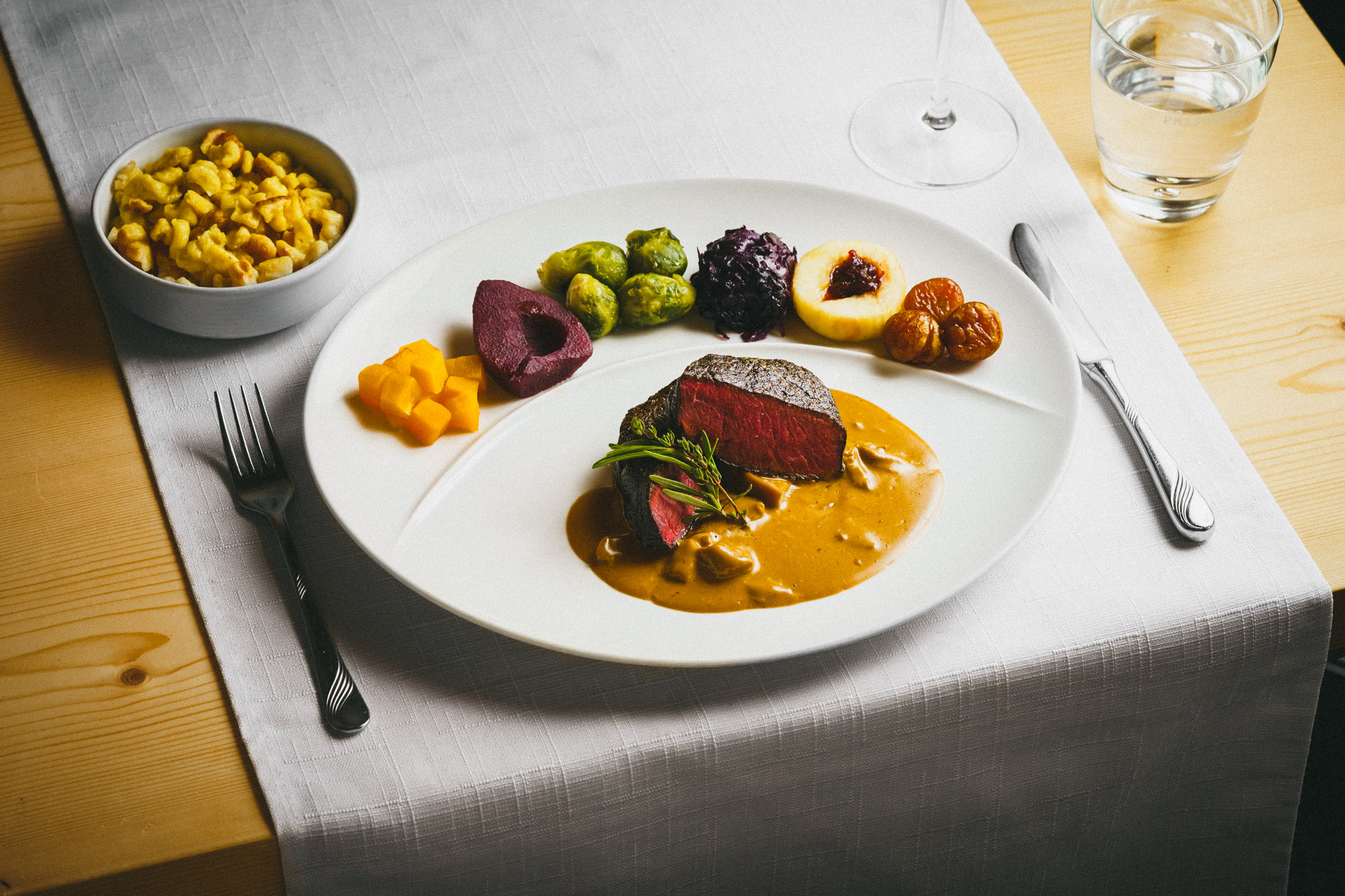 Dish: Venison entrecôte with porcini cream sauce, served with vegetables from our own garden and homemade spaetzle – Brigels