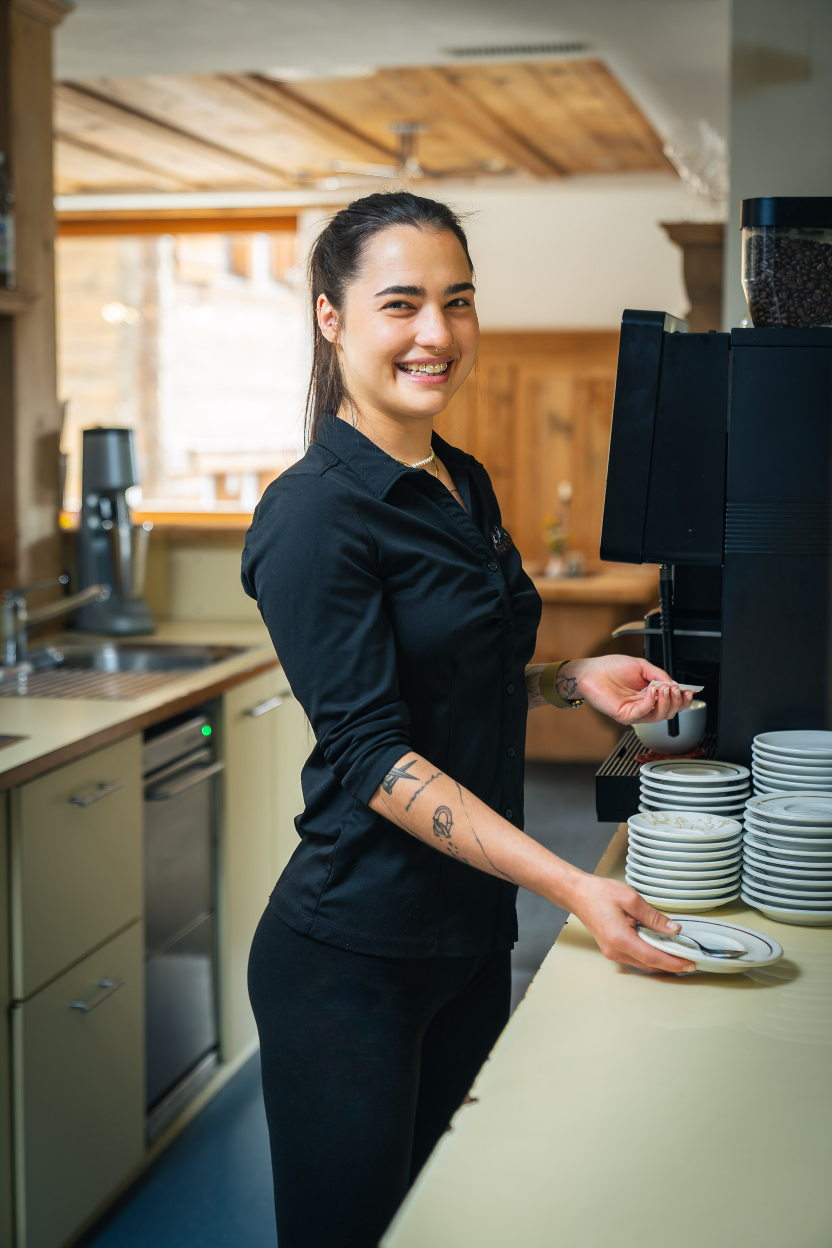 Vanessa, kitchen assistant and server, preparing coffee in the restaurant