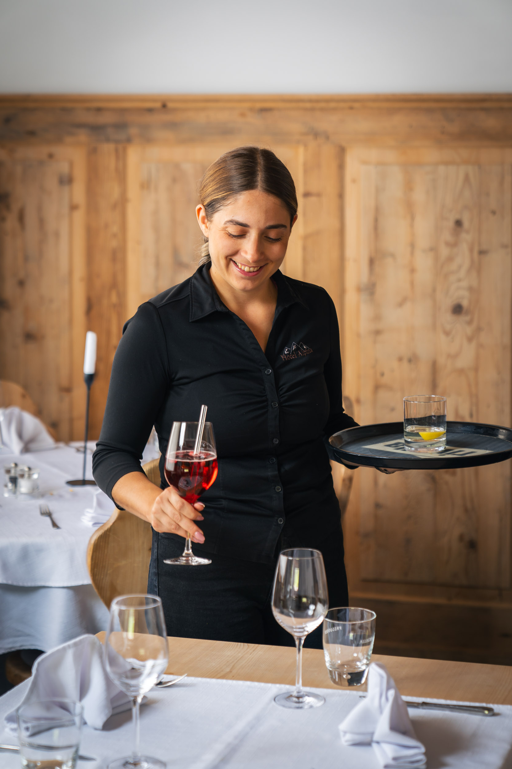 Daniela, serving Aperol Spritz in the restaurant