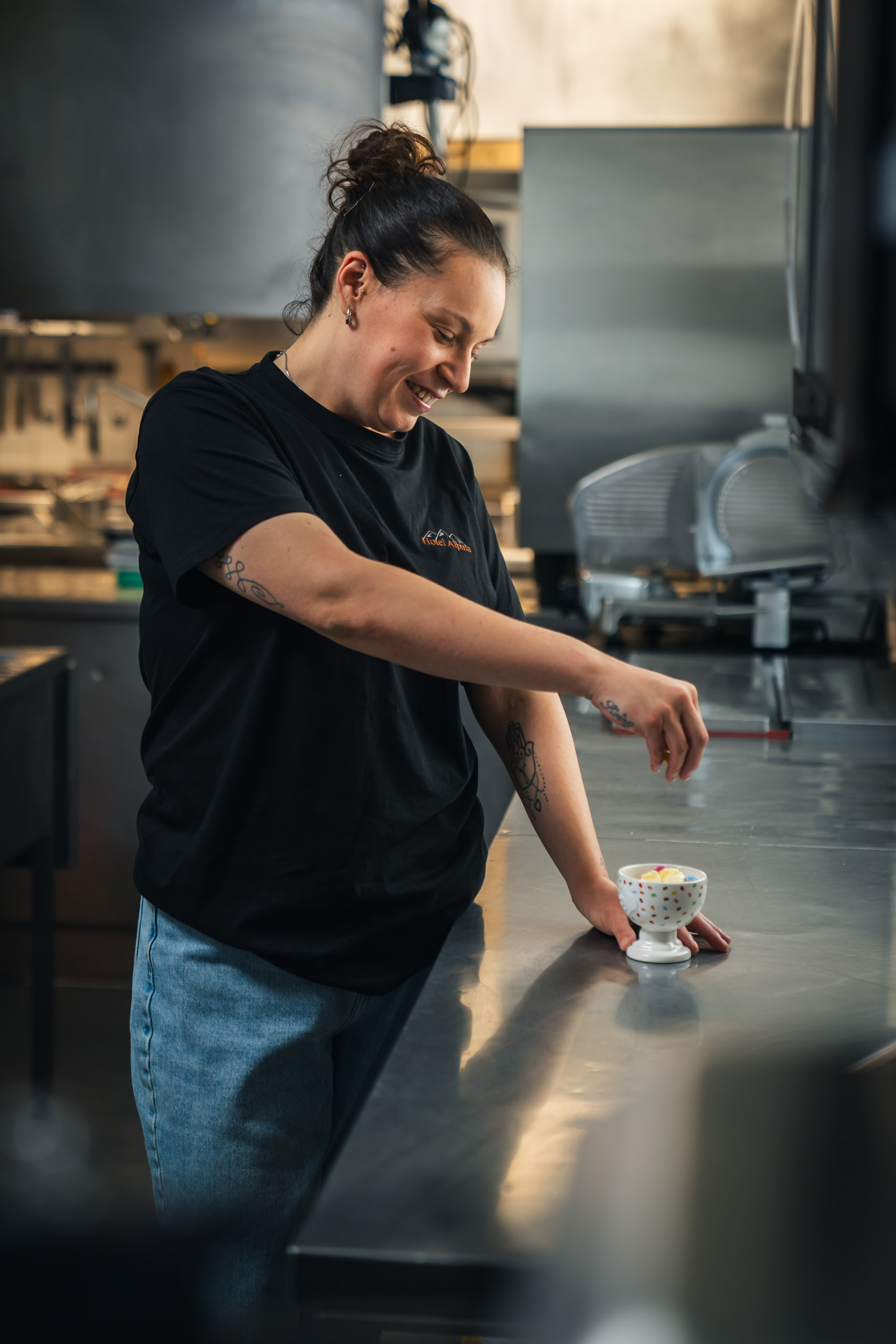 Vanessa, kitchen assistant, garnishing a dessert sundae for children