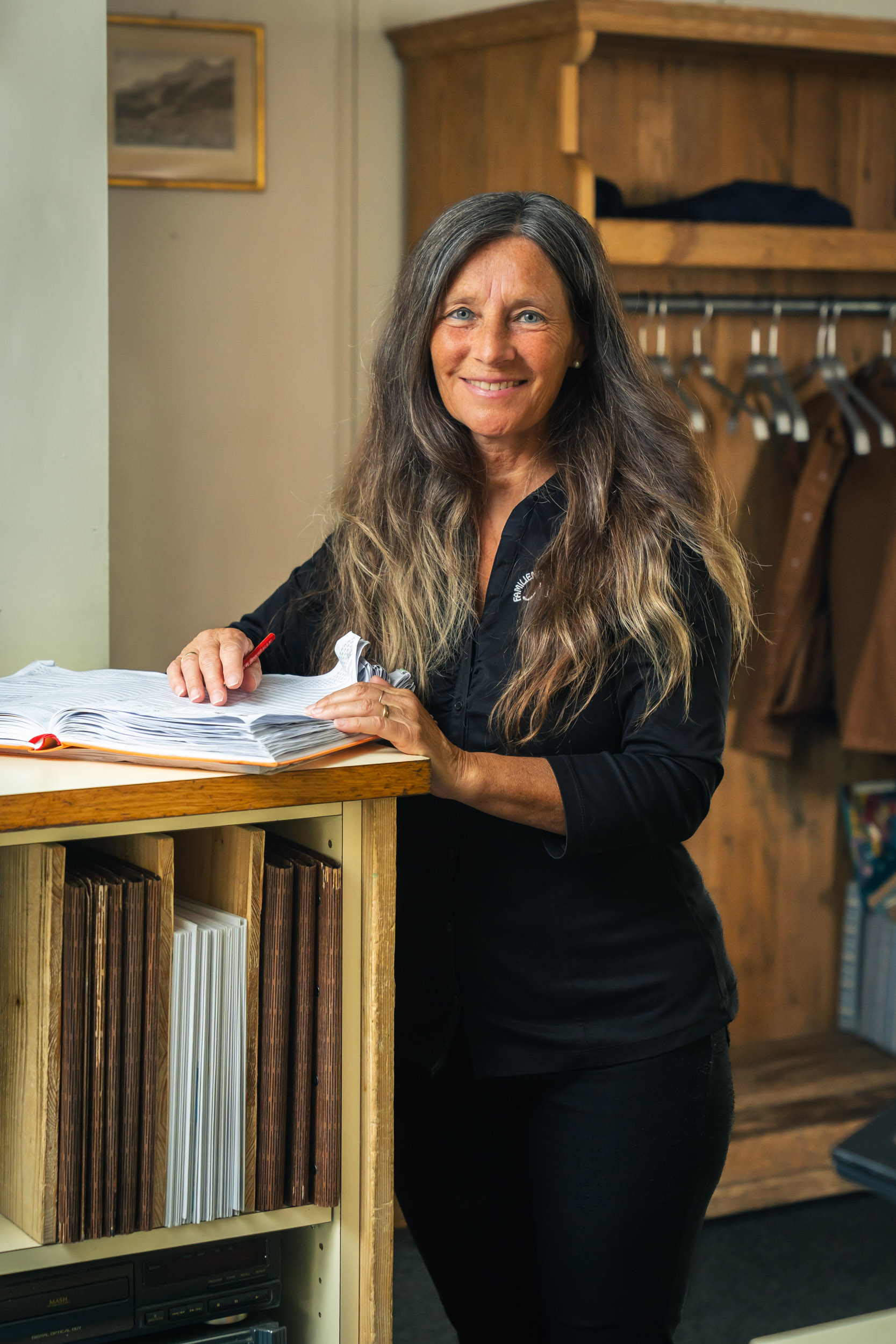 Rosina, owner and host, entering reservations in the book