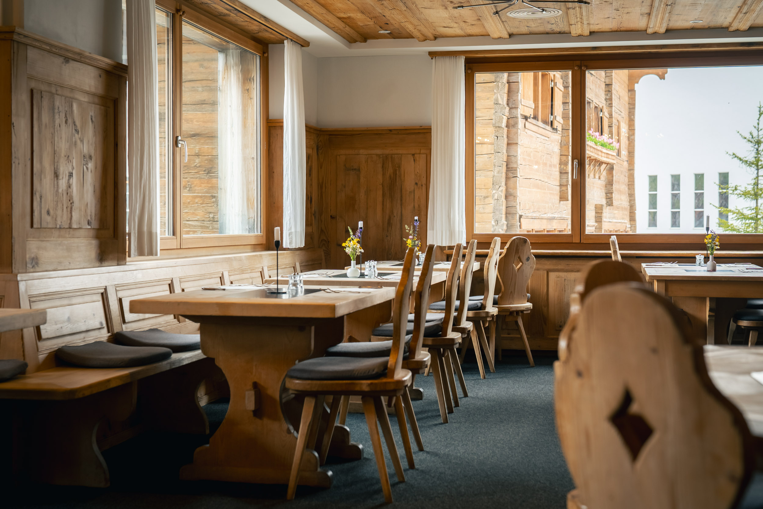 Tables in the restaurant of Hotel Alpina Brigels