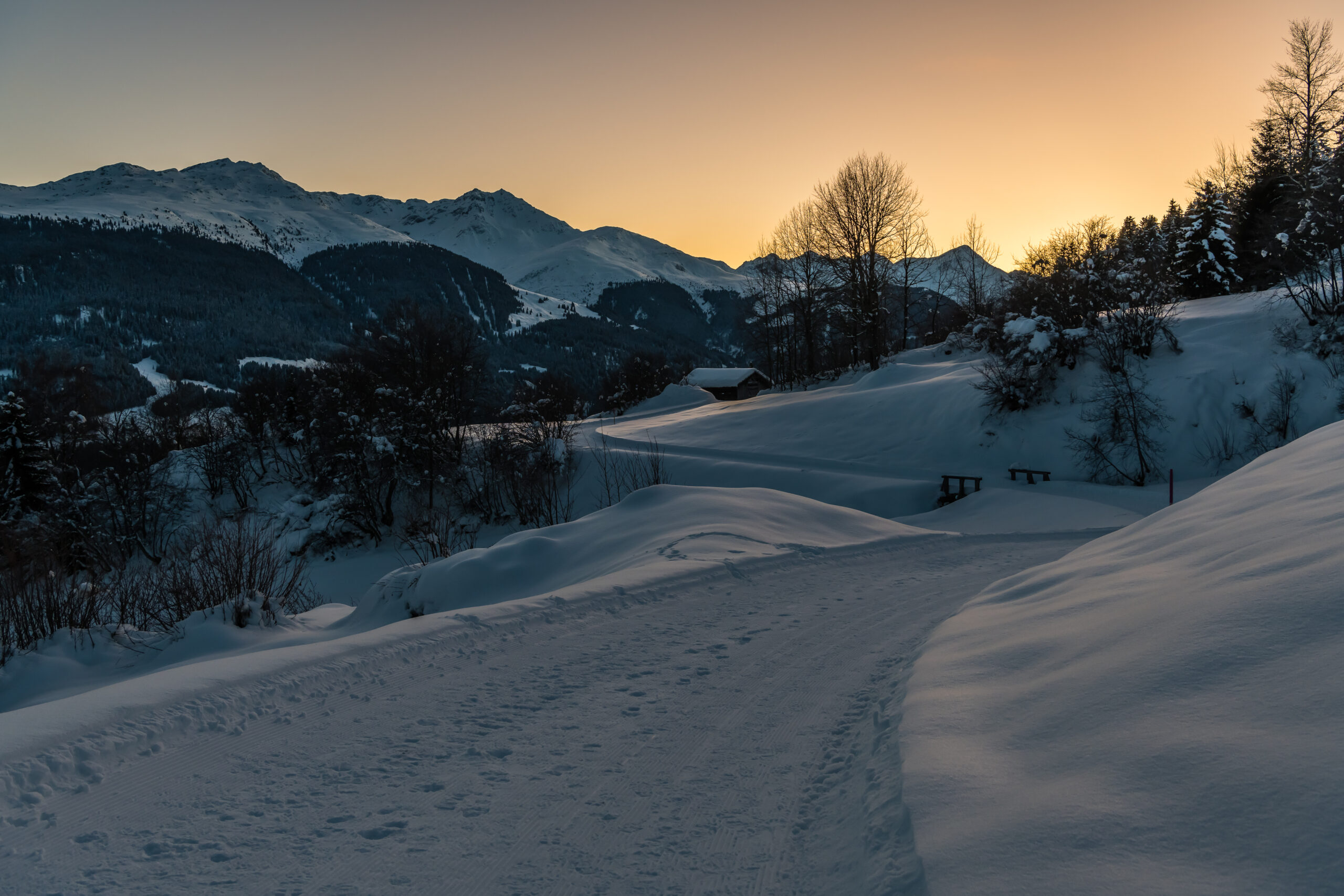 Winter hiking trails in Brigels at sunset
