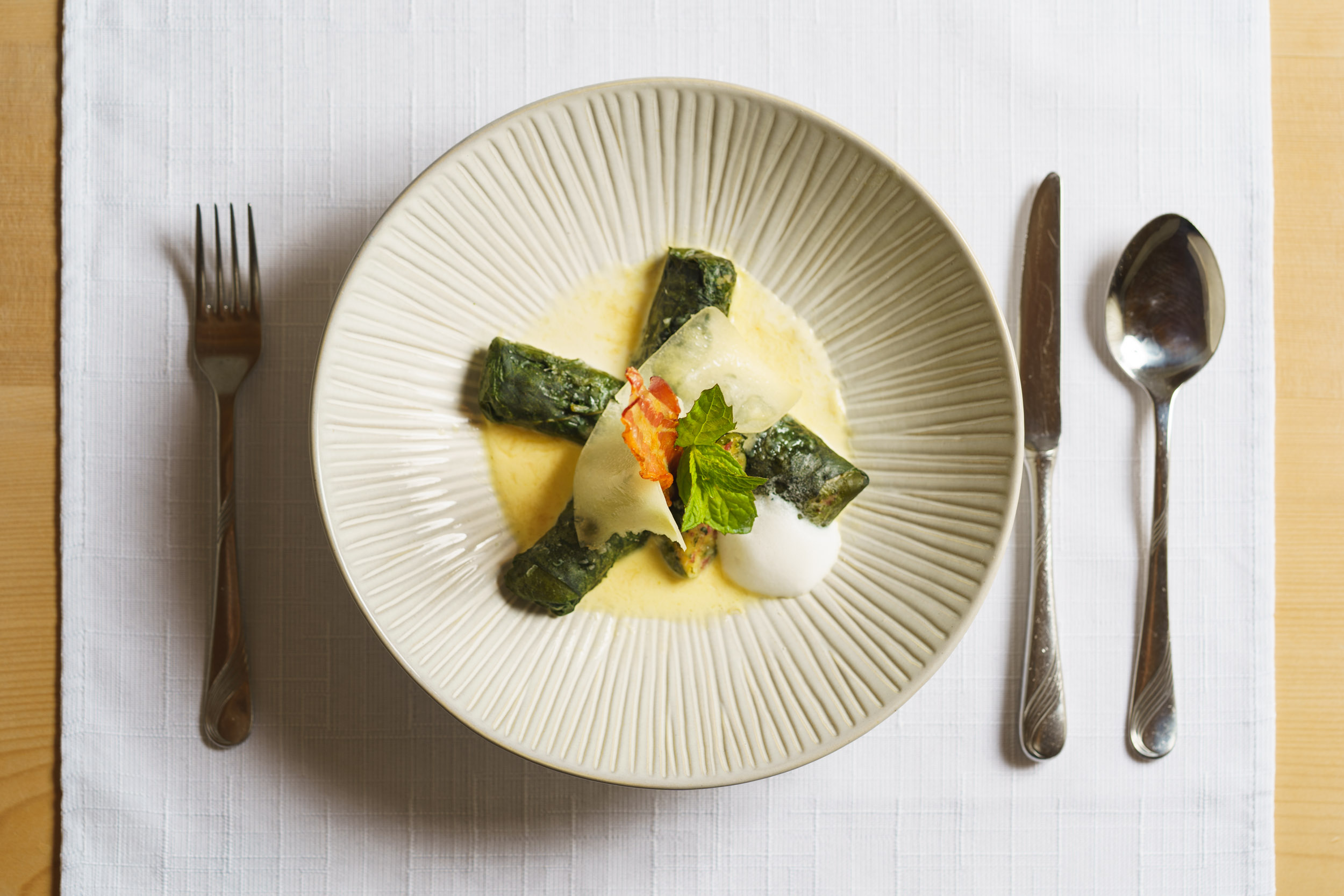 Dish: The house specialty Capuns Sursilvans, baked with cheese and bacon in a creamy broth sauce – Brigels