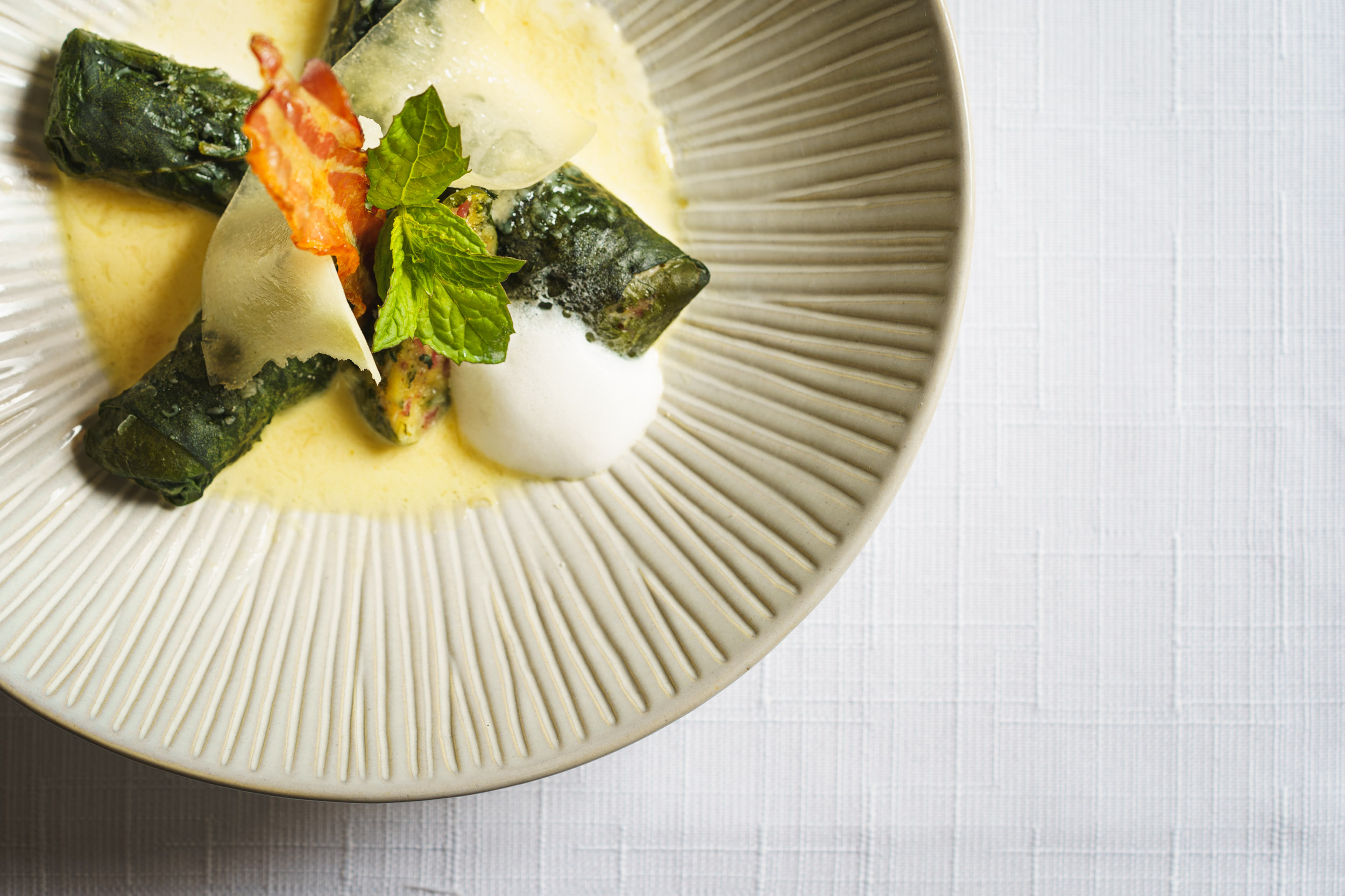 Restaurant: The house specialty Capuns Sursilvans, baked with cheese and bacon in a creamy broth sauce